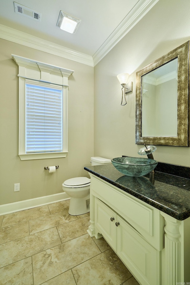 bathroom with vanity, toilet, and crown molding