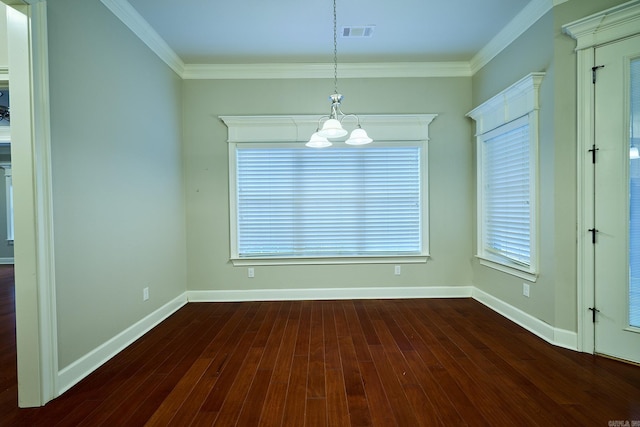 unfurnished dining area with a healthy amount of sunlight, ornamental molding, and a chandelier