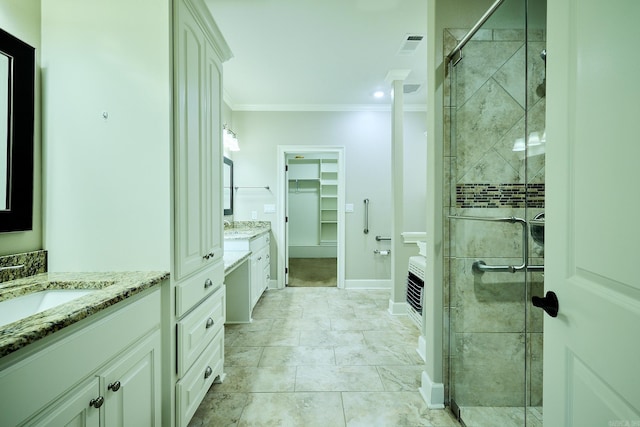 bathroom featuring crown molding, vanity, and a shower with shower door