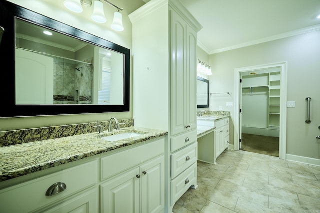 bathroom with crown molding, vanity, and a shower with shower door