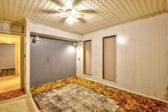 interior space featuring carpet and wooden walls