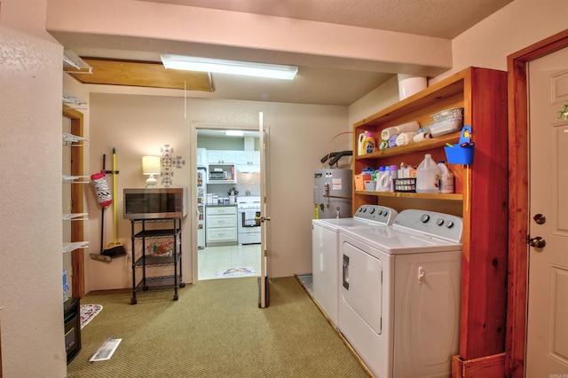 laundry area with strapped water heater, light colored carpet, and washing machine and dryer