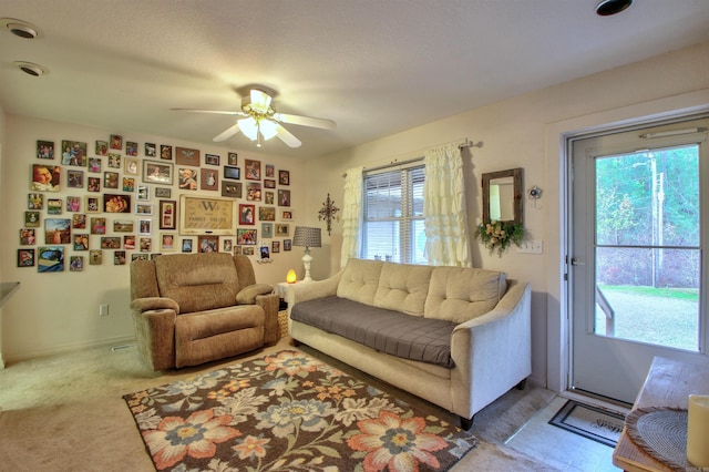 carpeted living room featuring a wealth of natural light and ceiling fan