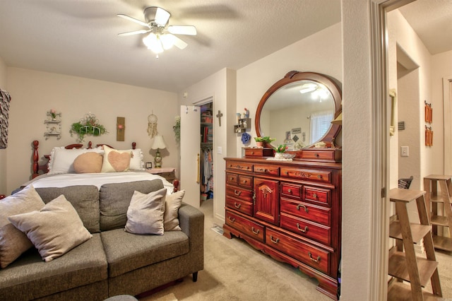 bedroom with light carpet, a closet, and ceiling fan