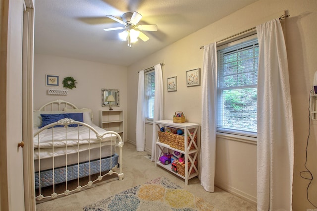 carpeted bedroom with ceiling fan