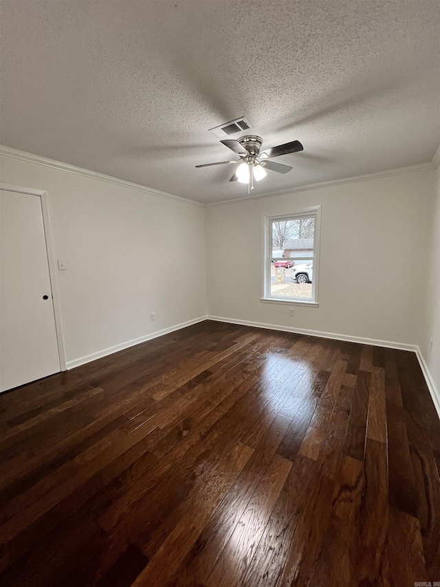 spare room featuring a textured ceiling, crown molding, ceiling fan, and dark wood-type flooring