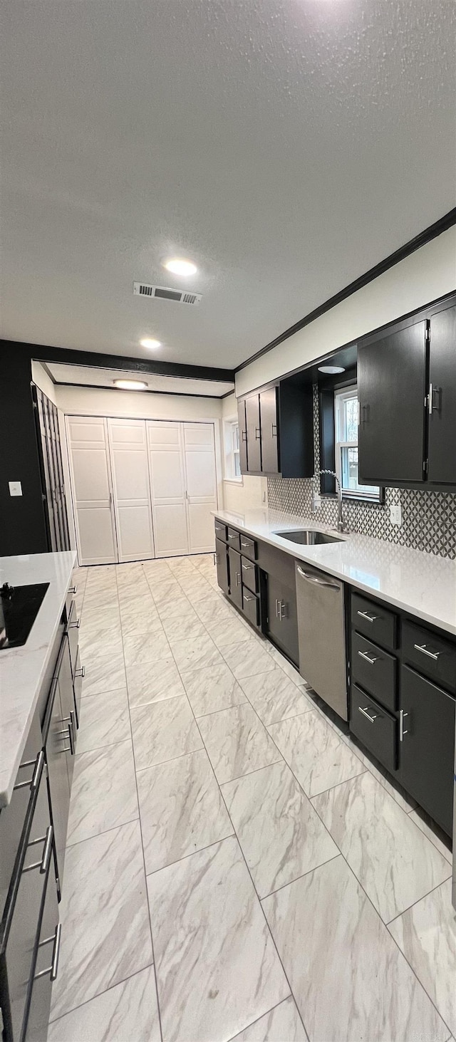 kitchen with dishwasher, black electric stovetop, sink, a textured ceiling, and tasteful backsplash