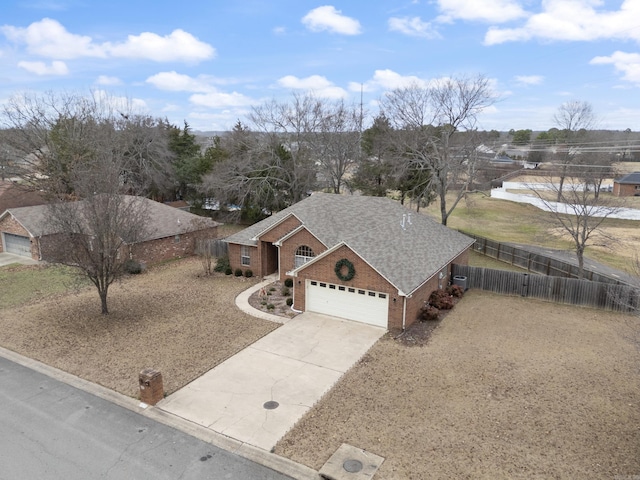 single story home with central AC unit and a garage