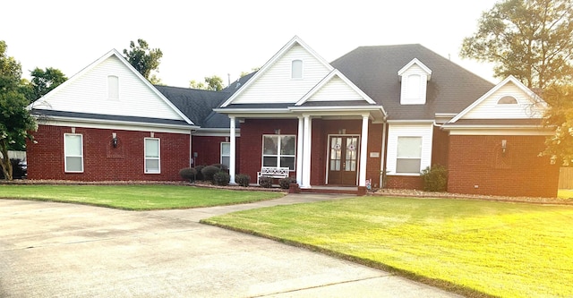 view of front of property featuring french doors and a front lawn