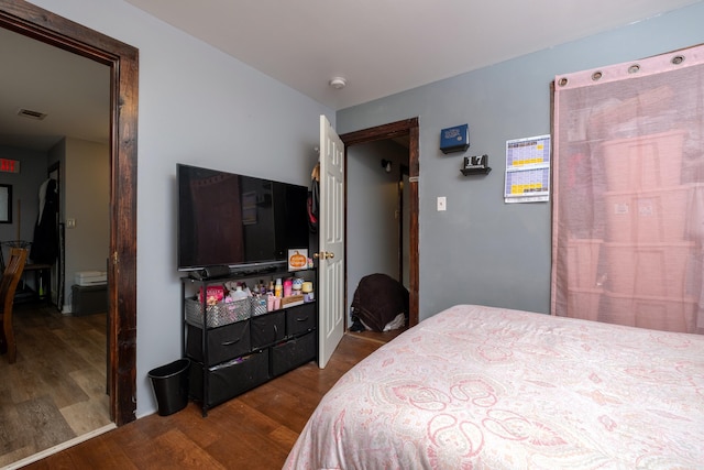 bedroom with wood-type flooring