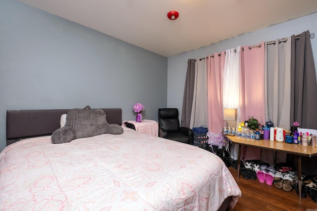 bedroom with dark wood-type flooring