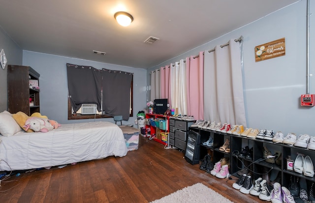 bedroom with dark hardwood / wood-style floors