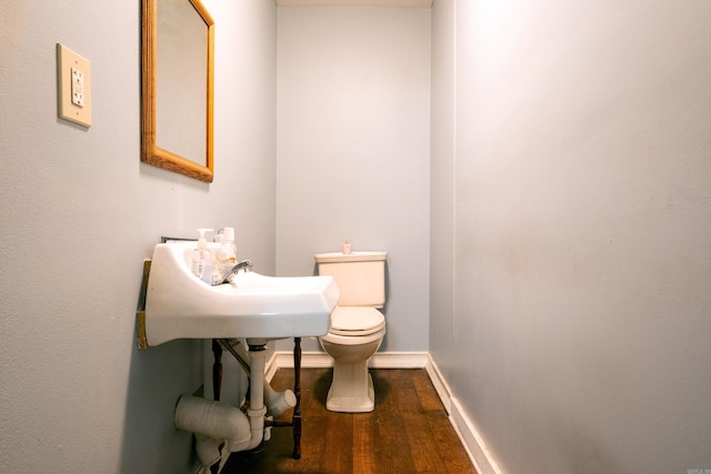 bathroom featuring toilet and wood-type flooring