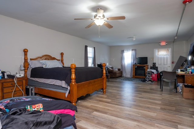 bedroom with light hardwood / wood-style flooring and ceiling fan