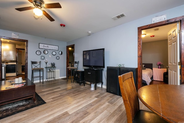 dining space featuring ceiling fan and light hardwood / wood-style floors