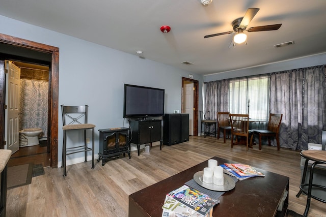 living room with light wood-type flooring and ceiling fan