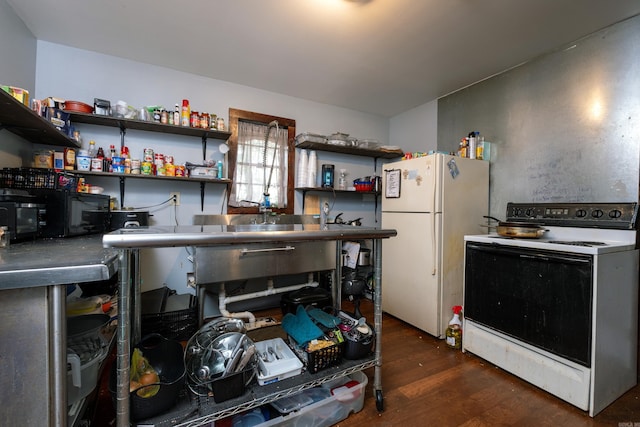 kitchen featuring dark hardwood / wood-style flooring, white appliances, and stainless steel counters