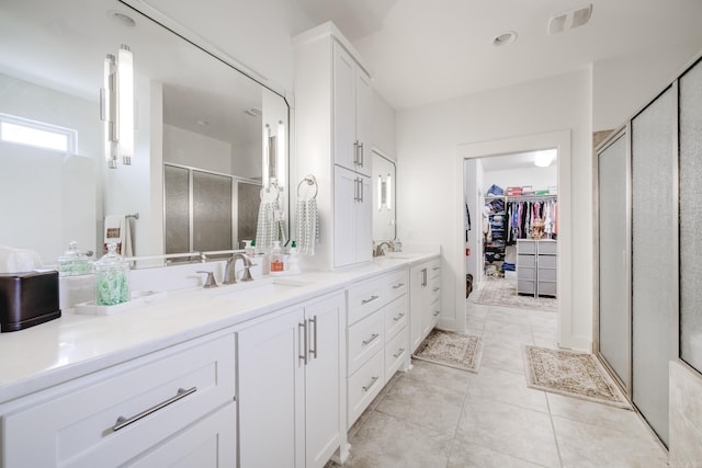 bathroom with tile patterned flooring, vanity, and an enclosed shower