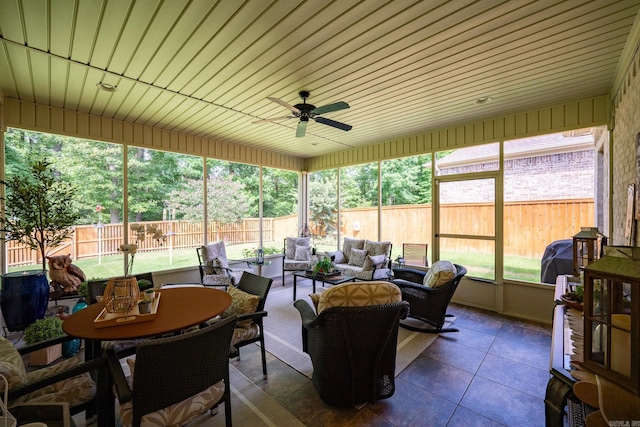 sunroom featuring ceiling fan