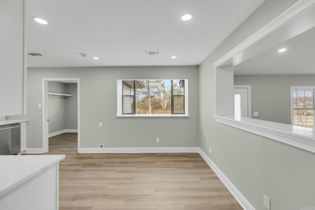 living room featuring light hardwood / wood-style floors and a textured ceiling