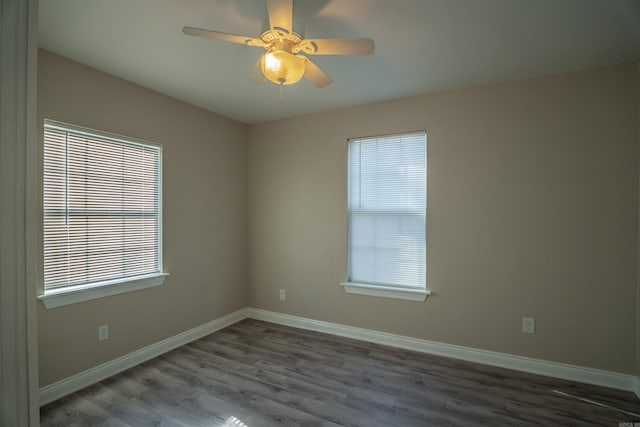 spare room featuring plenty of natural light, ceiling fan, and wood-type flooring