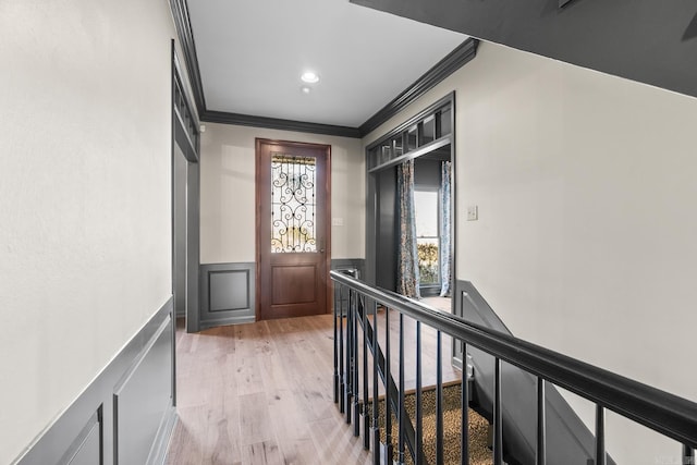 hall with crown molding and light wood-type flooring