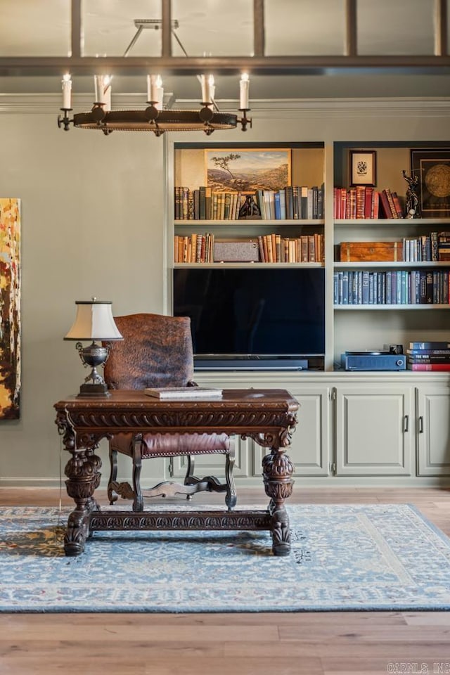 miscellaneous room featuring a chandelier, hardwood / wood-style flooring, and crown molding