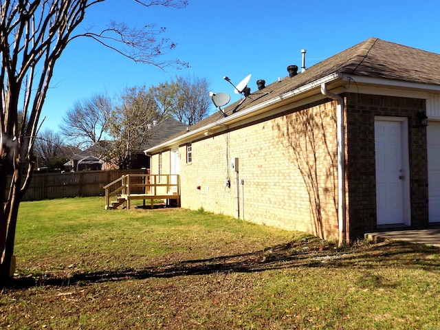 view of side of home with a lawn