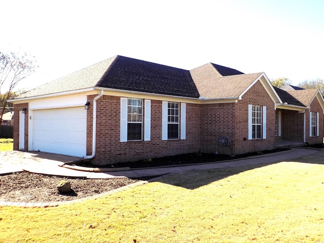 view of front of home featuring a garage and a front lawn