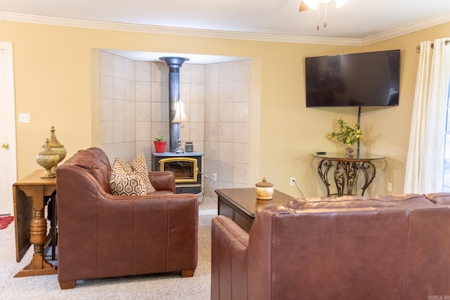 living room with a wood stove, crown molding, ceiling fan, and light carpet