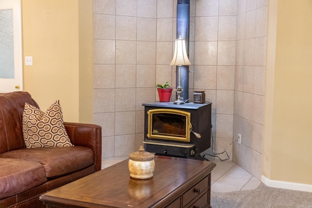 living room featuring light tile patterned floors, a wood stove, and tile walls