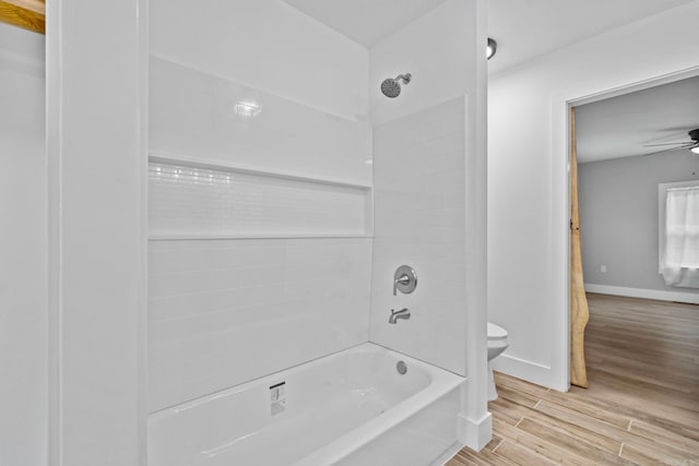 bathroom featuring shower / tub combination and toilet