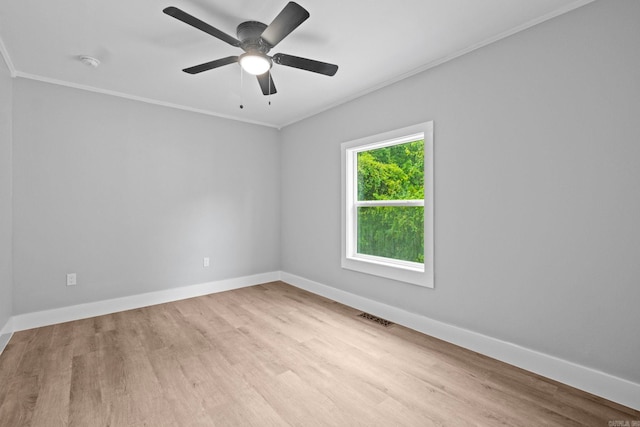 spare room featuring light wood-type flooring, ceiling fan, and ornamental molding