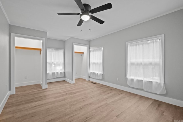 unfurnished bedroom featuring ceiling fan, light wood-type flooring, and a closet