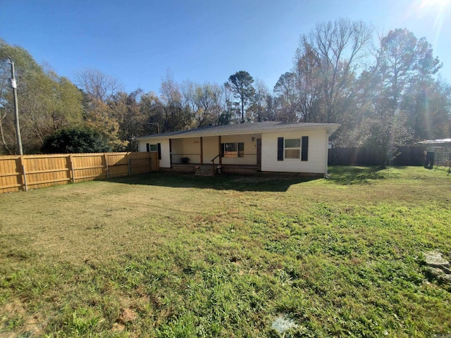 rear view of property with a yard