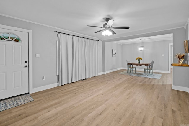 foyer entrance with ceiling fan with notable chandelier, light hardwood / wood-style flooring, and ornamental molding