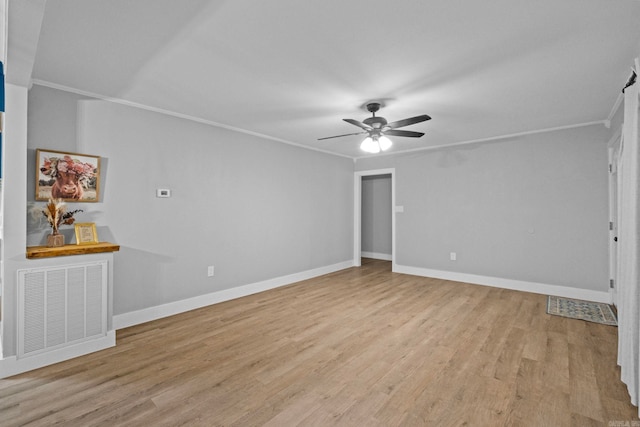 empty room with ceiling fan, light hardwood / wood-style floors, and crown molding