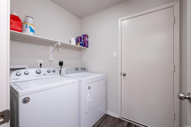 laundry area featuring washing machine and clothes dryer and dark wood-type flooring