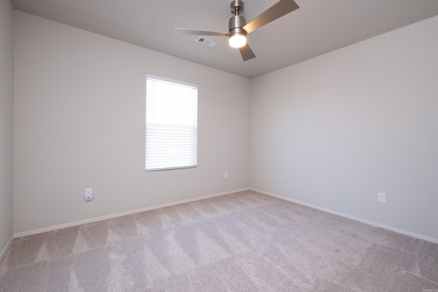 carpeted empty room featuring ceiling fan