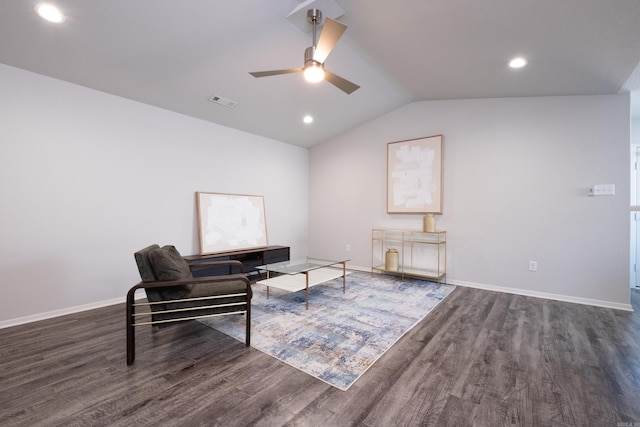 living area with ceiling fan, dark hardwood / wood-style flooring, and lofted ceiling