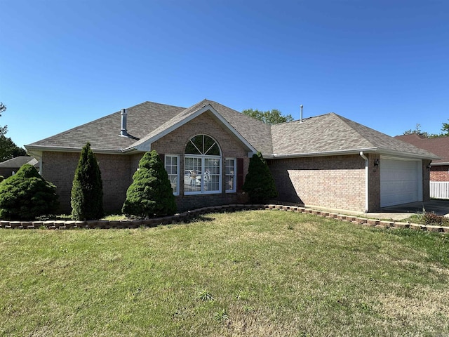 ranch-style house featuring a garage and a front lawn