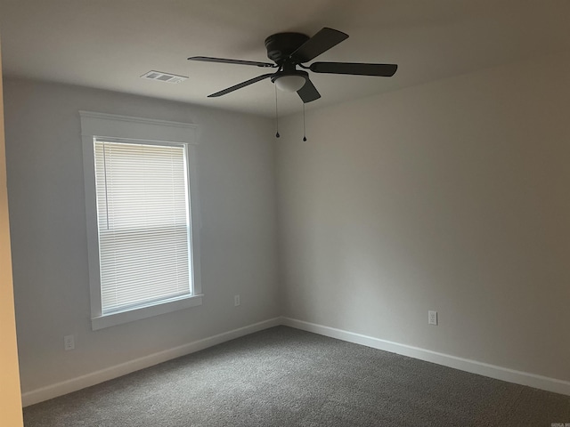 carpeted spare room with plenty of natural light and ceiling fan