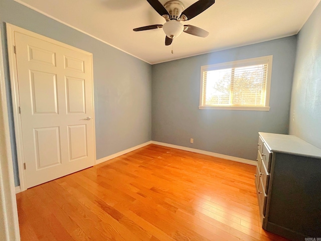 unfurnished bedroom with ceiling fan and hardwood / wood-style floors