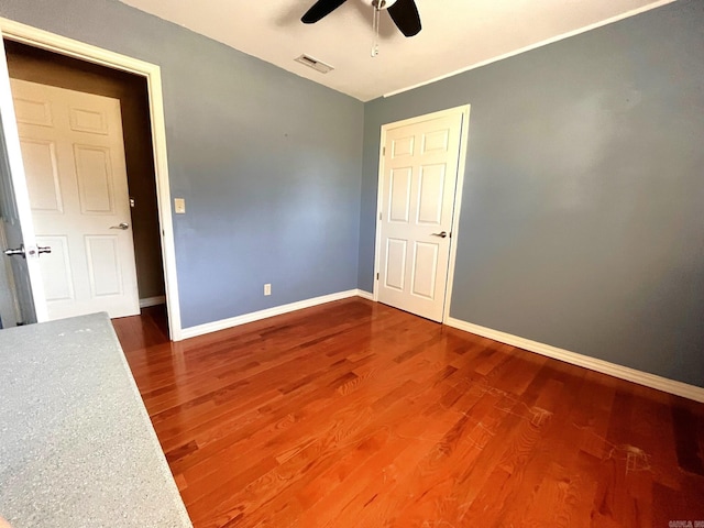 empty room with hardwood / wood-style flooring and ceiling fan