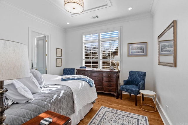 bedroom with light hardwood / wood-style flooring and crown molding