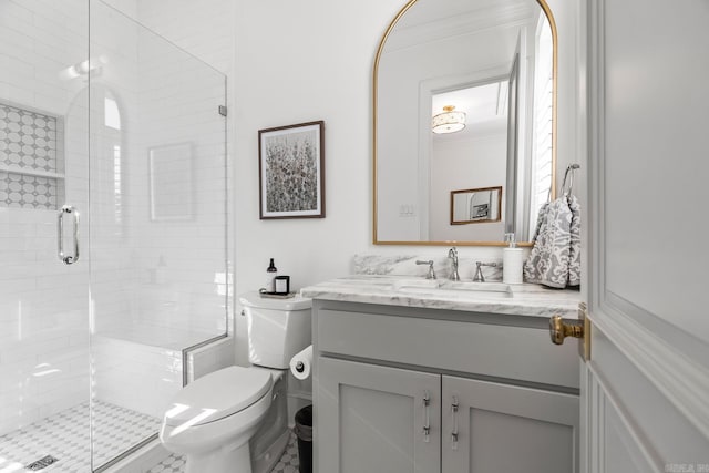 bathroom featuring vanity, toilet, an enclosed shower, and crown molding