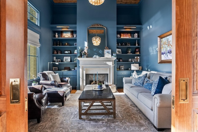 sitting room featuring a chandelier, a high ceiling, and built in features