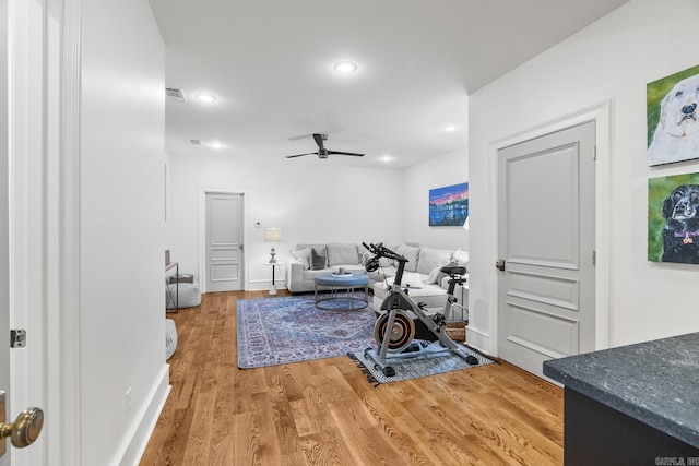 exercise room with hardwood / wood-style flooring and ceiling fan