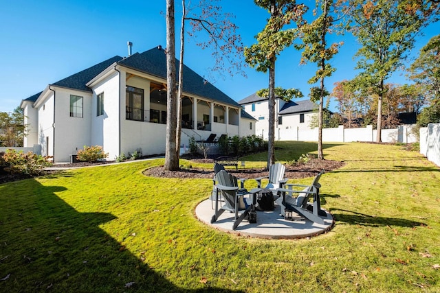 rear view of house featuring a yard, a patio, and ceiling fan