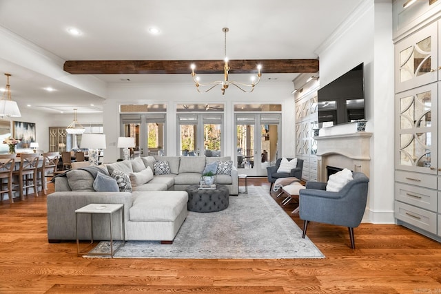 living room featuring hardwood / wood-style floors, beamed ceiling, a chandelier, and french doors